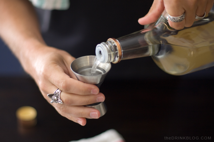 pouring titos vodka for the honey deuce